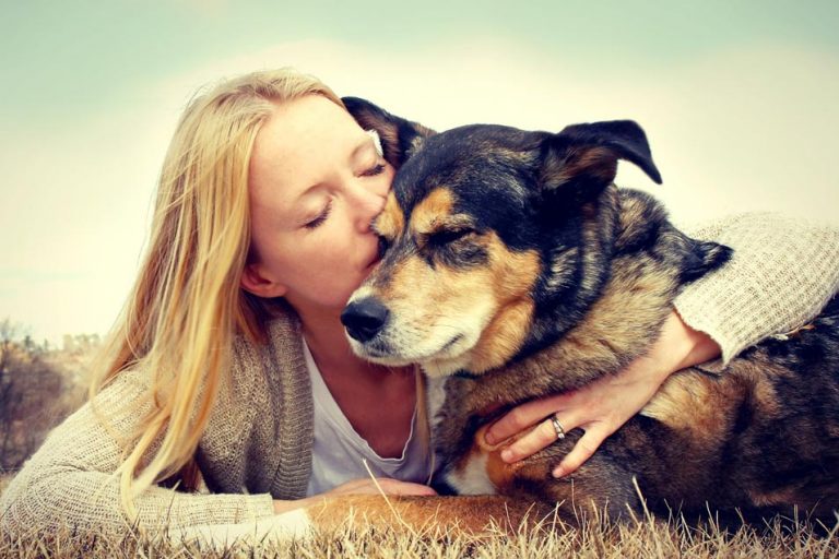 Picture of a woman kissing a old dog