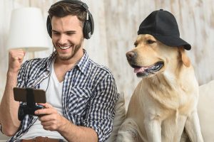 Picture of man and his dog looking at a phone