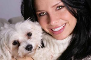 Picture of a Maltese dog and a woman