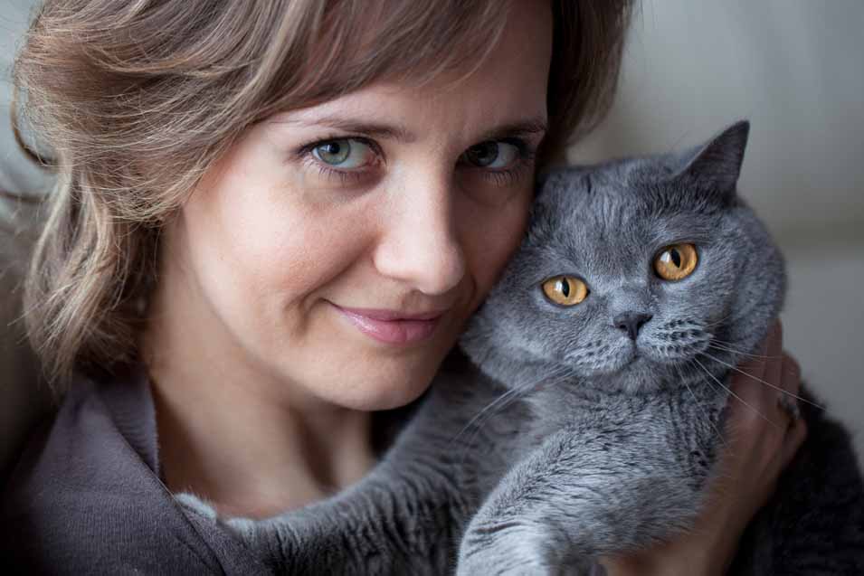Picture of a woman holding a grey cat