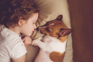 Picture of a girl and dog sleeping
