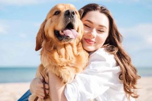 Picture of a woman hugging a Golden Retriever