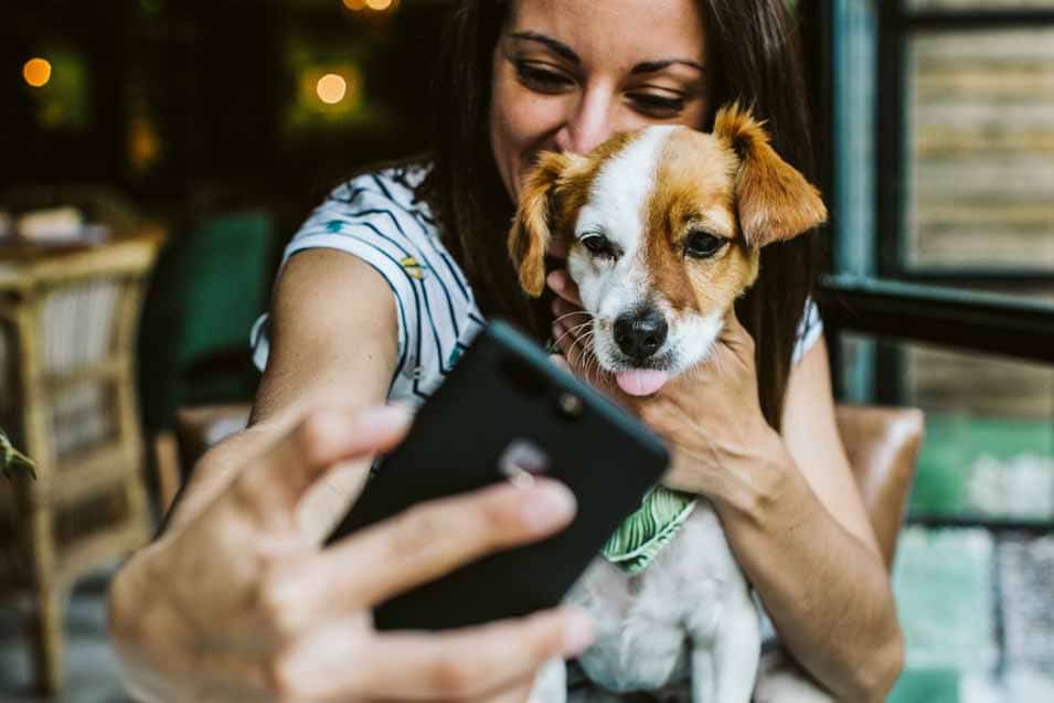 Picture of a woman taking a selfie with her dog