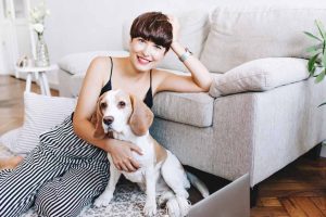 Picture of a woman and dog by a sofa