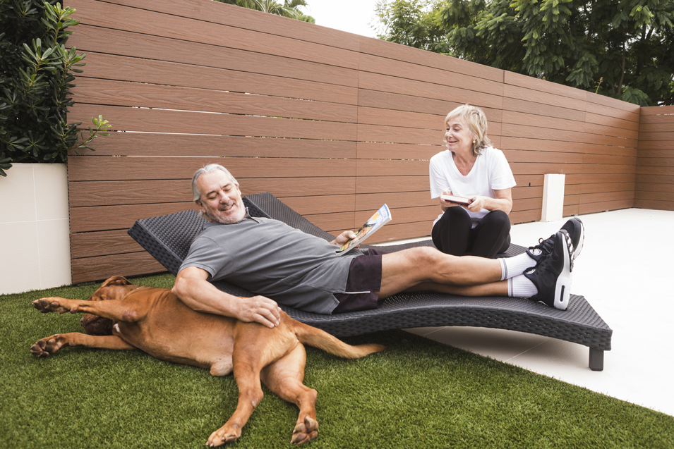 couple in the backyard with their dog