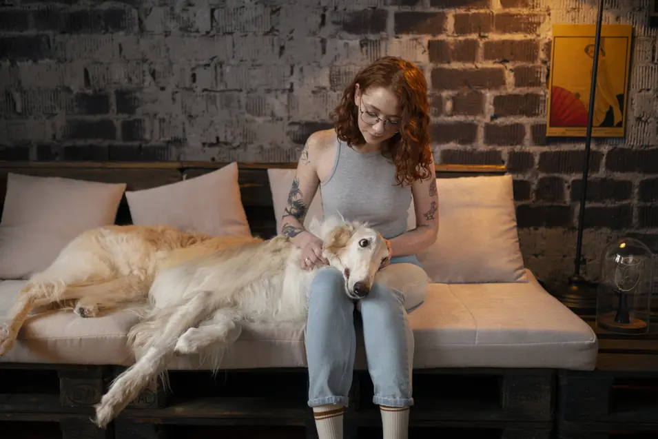 woman petting her dog in the basement