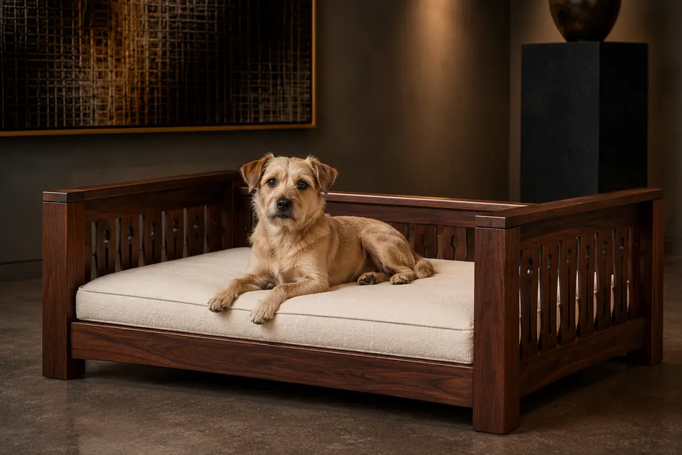 Luxury Arts & Crafts-style walnut dog bed with handcrafted slatted sides, a plush cream cushion and timeless craftsmanship in a gallery-inspired setting.