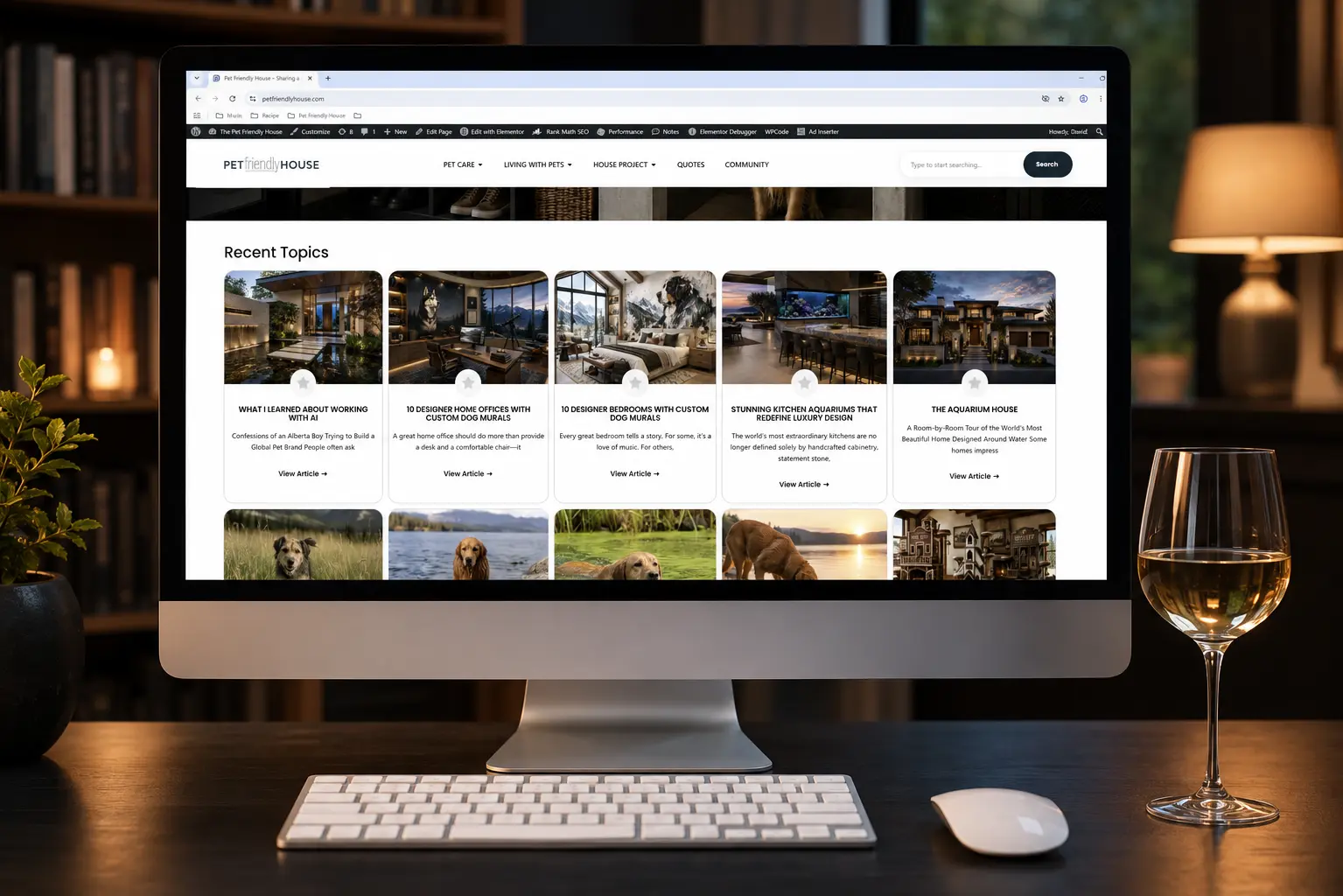 Working late on Pet Friendly House, a desktop displays the latest articles while a glass of chilled Chardonnay, keyboard, and mouse create the perfect setting for a relaxing evening of writing and creativity.