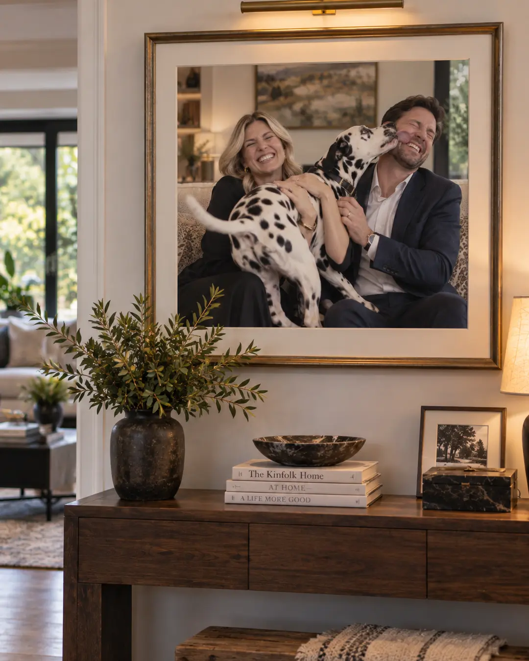 A framed family portrait captures a Dalmatian enthusiastically ruining the perfect photo by licking Dad’s face.